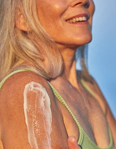 Woman with moisturizer applied to her shoulder.