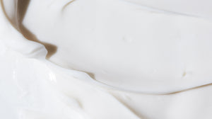 Close up of a LATHER face moisturizing product, emphasizing rich and creamy texture.