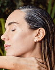 Person with eyes closed and Avocado Mint Scalp Scrub applied to their hair.