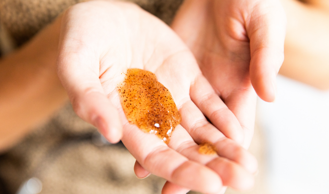 Woman holding unidentified cosmetic product in her hand
