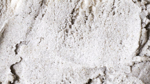 Close up image of body scrub product, emphasizing the texture of the scrub.