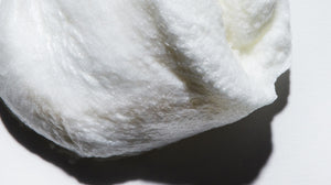 Close up of LATHER Almond Shave Crème, emphasizing the softly whipped texture.