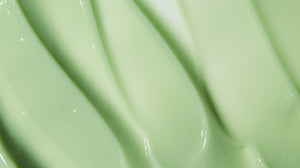 Close up of light green LATHER conditioner product, emphasizing rich creamy texture.