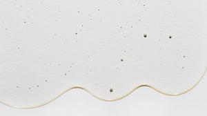Close up of LATHER hair wash product, emphasizing viscosity and texture.
