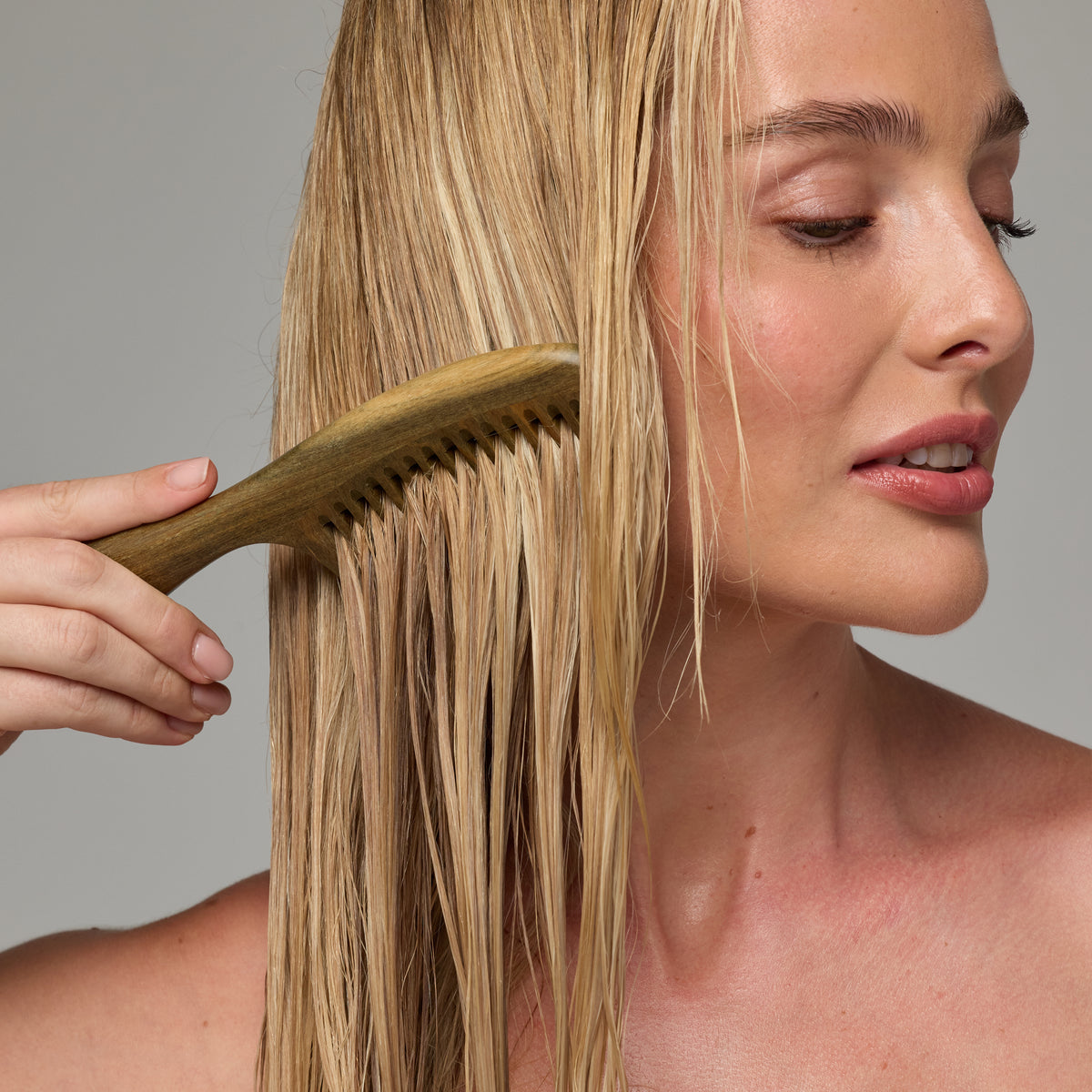 Combing serum through damp hair