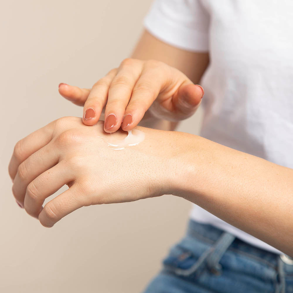 Model applying Hand Therapy to back of hand