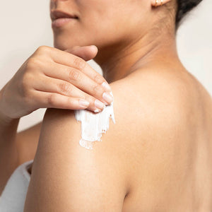 Women applying Bamboo Lemongrass BodyCrème to her shoulder.