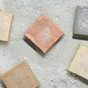 Variety of LATHER bar soaps in sudsy water